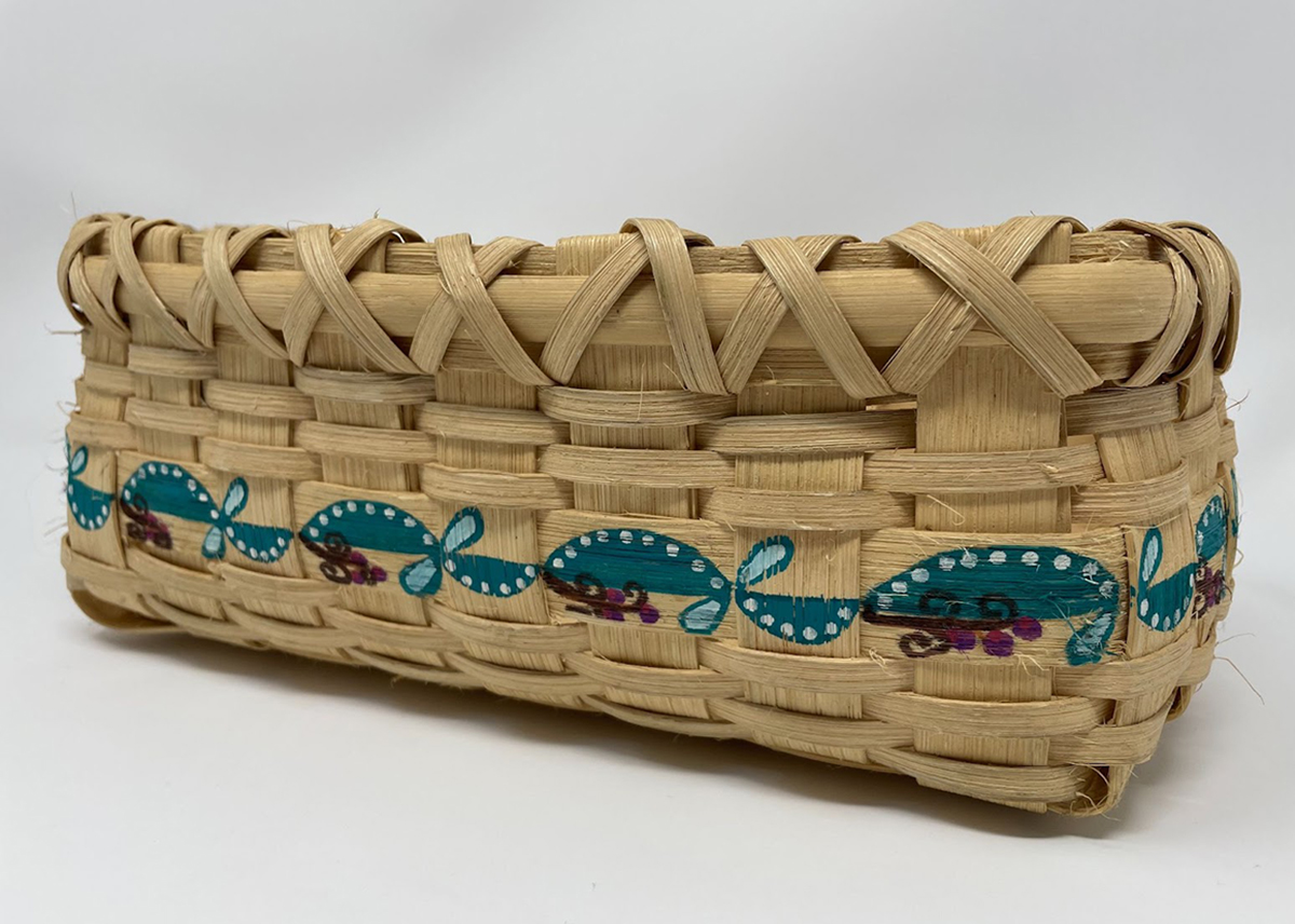 Flat reed splint basket with stamped turquoise design.